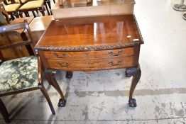 An early 20th Century mahogany cutlery canteen having gadrooned edge, cabriole legs and ball and