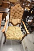 A traditional stained frame armchair having bergere back