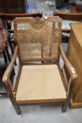 A stained frame bergere back armchair