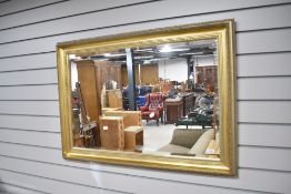 A gilt frame wall mirror in the classical style