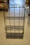 A modern metal wall shelf, waterfall form