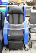 A disability aid chair , wheeled function and food tray