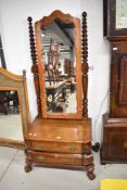 A reproduction mahogany Cheval mirror, the oblong plate with shaped surround between barley twist