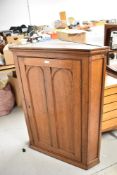 A 19th Century oak corner cupboard the single door with double arched panels. 110CM.