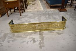 A Victorian pierced brass fire fender