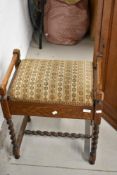 An early 20th Century oak piano stool having twist frame