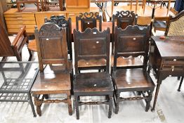 A harlequin set of period oak panelled solid seat chairs