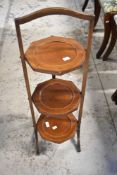 An Edwardian mahogany folding cake stand