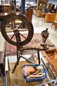 A traditional stained frame spinning wheel and accesories