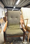 A vintage stained frame low seat easy chair