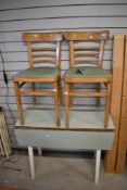A vintage formica top kitchen table and two chairs