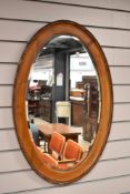 An early 20th Century mahogany oval wall mirror
