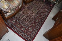 A traditional carpet square , red ground