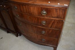 An early 20th Century Regency revival bow fronted chest of two short over four long shaped drawers