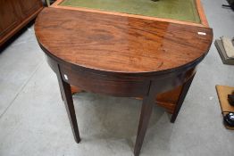 A 19th Century mahogany demi lune fold over table