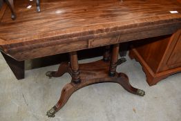 A 19th Century mahogany fold over tea table having canted corners and line inlay decoration of