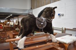 A vintage plush rocking horse, missing stirrups