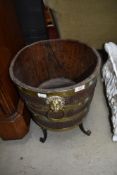 A period oak and brass bound barrel style planter having lion mask handle , on cast stand