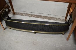 A Victorian brass pierced fire fender