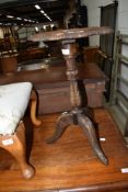 An interesting occasional table/candle stand having extensive carving throughout on triple splay