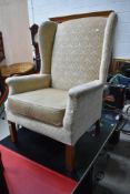 A reproduction easy armchair, nice quality heavy frame and wingbacks