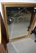 A gilt frame wall mirror having mottled effect