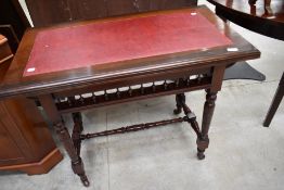 A 19th Century mahogany side table having leather insert, spindle undergallery and turned frame with