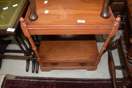 A reproduction yew effect occasional table with under shelf and drawer to base
