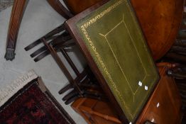 A reproduction period style nest of three tables having skiver tops