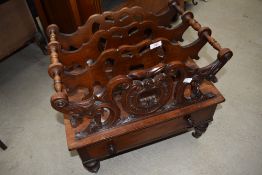 A 19th Century mahogany Canterbury having drawer base on turned legs and brass castors