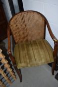 An early 20th Century mahogany framed armchair having upholstered seat and bergere back