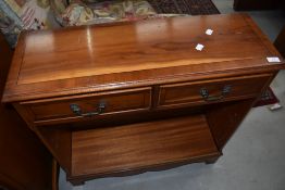 A reproduction yew wood low bookcase