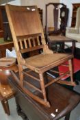 A Victorian stripped stained frame rocking chair and an Edwardian cane seated bedroom chair