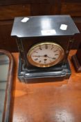 A Victorian black slate mantel clock of small proportions