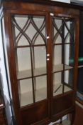 An early 20th Century mahogany display cabinet on delicate cabriole legs