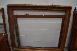 An oversized gilt picture or mirror frame