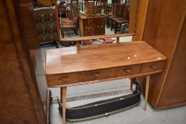 An Ercol mid or light stain dressing table