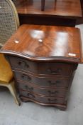 A reproduction Regency serpentine fronted small chest of four drawers