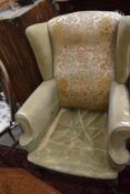 A period style wing back armchair, upholstery in poor condition but frame seems sound