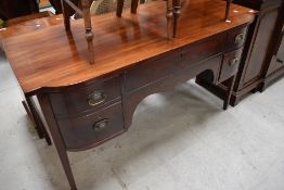 A 19th Century mahogany sideboard in a Regency design on tapered legs with spade feet