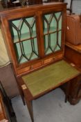 A reproduction yew wood side cabinet of small proportions having display top and fold over desk