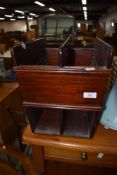 A modern mahogany magazine rack
