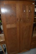An Ercol mid or light stain wardrobe
