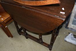 A nice quality period style reproduction oak gateleg dining table