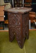 A carved oak plant stand