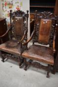 A pair of 19th Century Carolean style armchairs having figural decoration to knops and arms