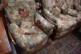 A modern three piece Ercol suite in mid stain, upholstery in good clean condition
