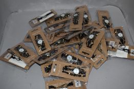 A collection of ladies fashion watches in various colours and designs, new in packaging.