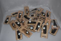 A collection of ladies fashion watches in various colours and designs, new in packaging