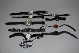 10 wrist watches all in black tones.